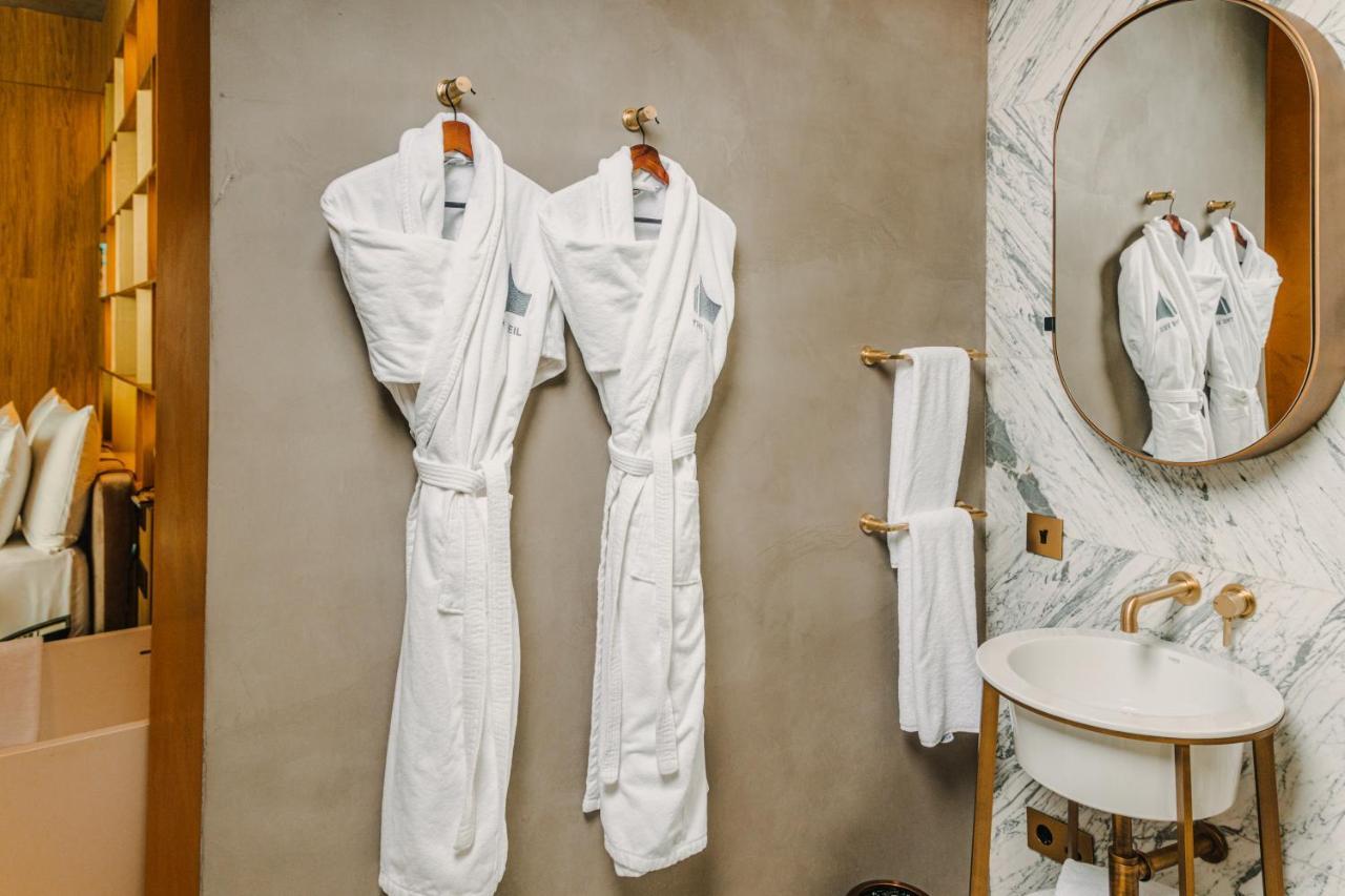 The Veil Hotel Astana Exterior foto Bathrobes in a hotel bathroom